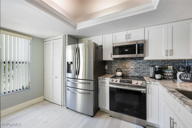15177 Parkside Dr Unit 104, Fort Myers, FL 33908 - kitchen with light stone counters, decorative backsplash, a raised ceiling, stainless steel appliances, and baseboards