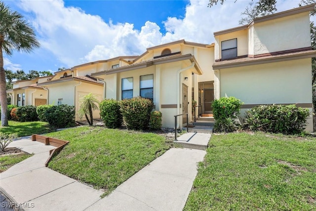 15177 Parkside Dr Unit 104, Fort Myers, FL 33908 - mediterranean / spanish house with a front lawn and stucco siding