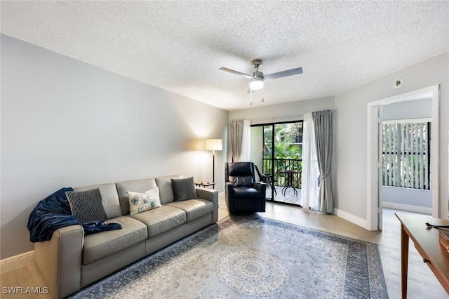 15177 Parkside Dr Unit 104, Fort Myers, FL 33908 - living room featuring a textured ceiling, a ceiling fan, and baseboards