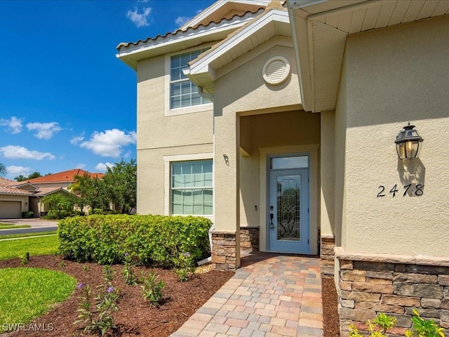 2478 Heydon Cir E, Naples, FL 34120 - doorway to property with stone siding and stucco siding