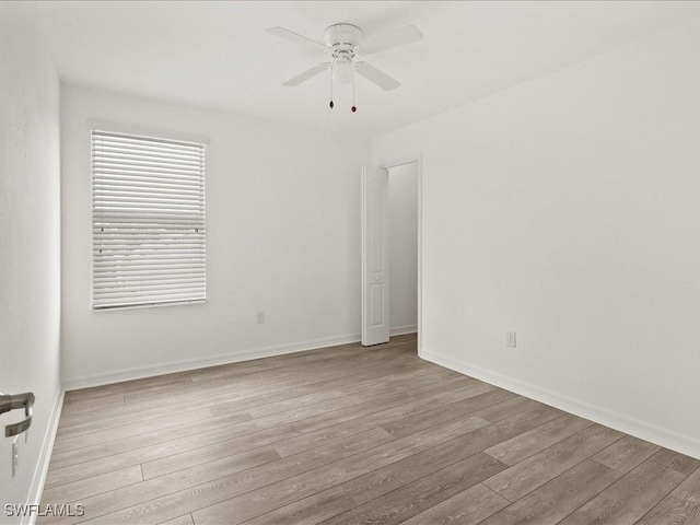 2478 Heydon Cir E, Naples, FL 34120 - empty room featuring baseboards, wood finished floors, and ceiling fan