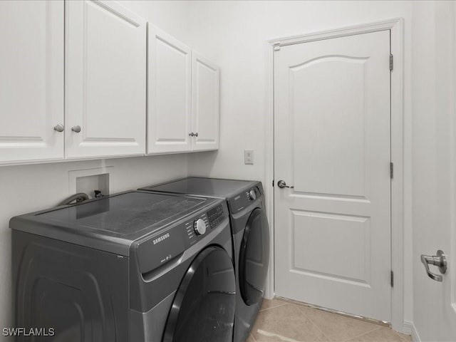 2478 Heydon Cir E, Naples, FL 34120 - washroom featuring light tile patterned floors, cabinet space, and washer and clothes dryer