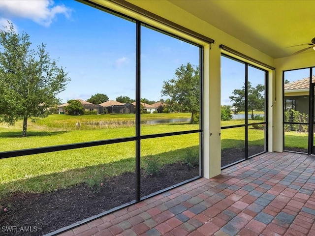2478 Heydon Cir E, Naples, FL 34120 - unfurnished sunroom with a ceiling fan and a water view