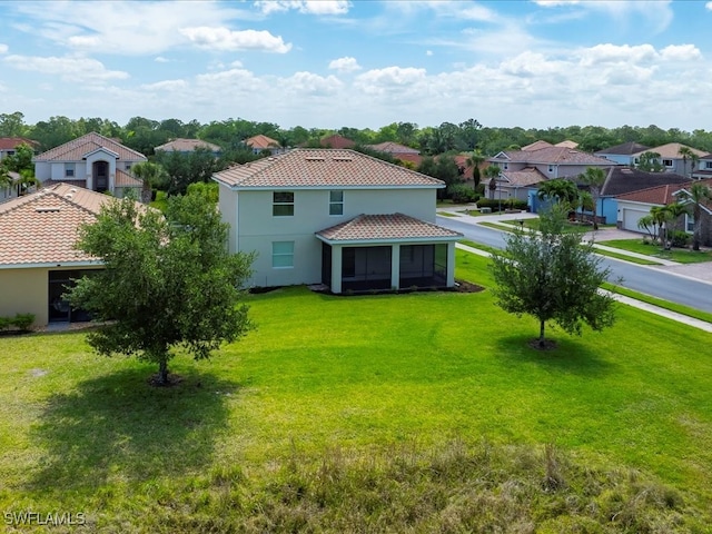2478 Heydon Cir E, Naples, FL 34120 - back of property with stucco siding, a yard, a residential view, and a tile roof