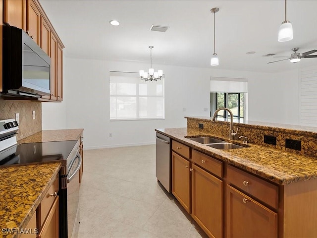 2478 Heydon Cir E, Naples, FL 34120 - kitchen featuring a sink, brown cabinets, stainless steel appliances, pendant lighting, and ceiling fan with notable chandelier