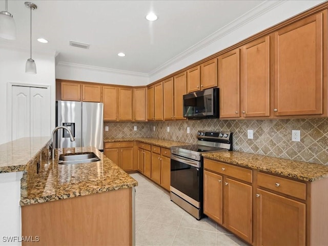 2478 Heydon Cir E, Naples, FL 34120 - kitchen featuring stainless steel appliances, brown cabinets, a sink, crown molding, and a center island with sink