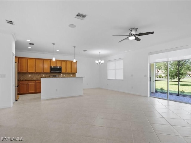 2478 Heydon Cir E, Naples, FL 34120 - unfurnished living room with visible vents, a wealth of natural light, and ceiling fan with notable chandelier