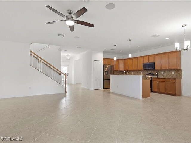 2478 Heydon Cir E, Naples, FL 34120 - kitchen with brown cabinets, decorative backsplash, appliances with stainless steel finishes, visible vents, and open floor plan