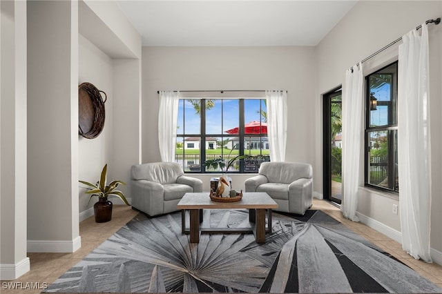 living room with baseboards and light tile patterned floors
