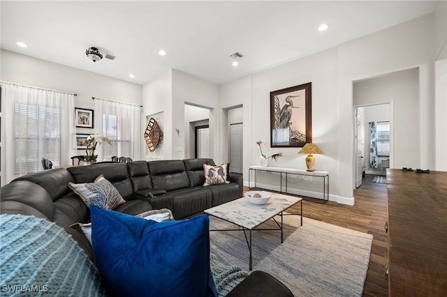 living room featuring recessed lighting, wood finished floors, visible vents, and baseboards