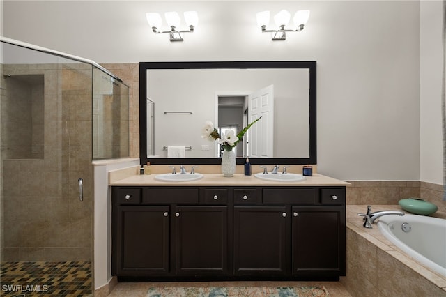 bathroom with a bath, a sink, double vanity, and a stall shower