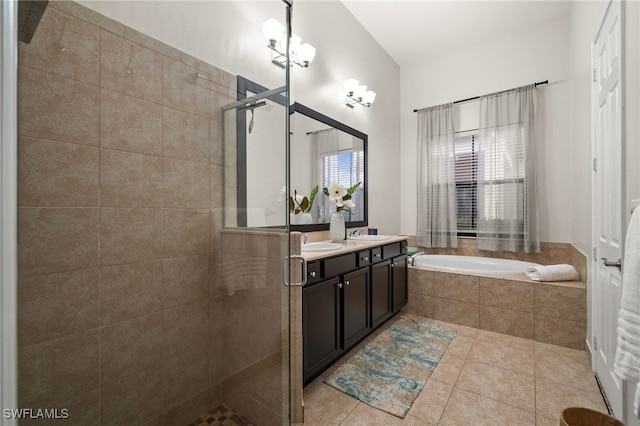 bathroom with a bath, a sink, double vanity, a stall shower, and tile patterned flooring