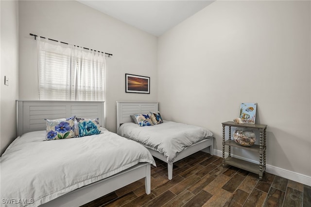 bedroom featuring wood finished floors and baseboards