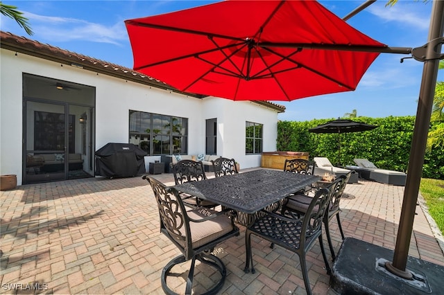 view of patio with a grill, outdoor lounge area, and outdoor dining space
