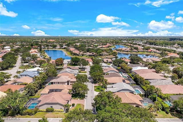 drone / aerial view featuring a residential view and a water view