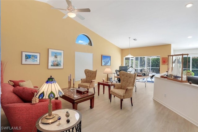 living room with baseboards, light wood-type flooring, recessed lighting, a ceiling fan, and high vaulted ceiling