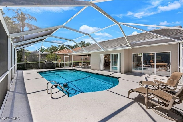 pool featuring a lanai and a patio area
