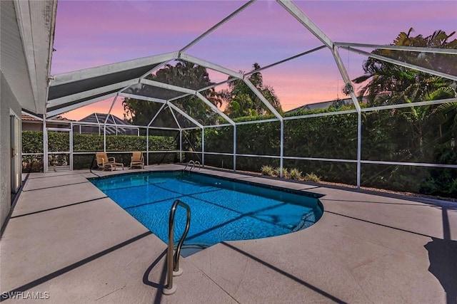 pool with glass enclosure and a patio area