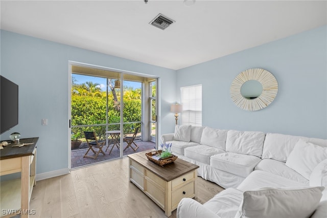 1305 Sweetwater Cv Unit 104, Naples, FL 34110 - living area with visible vents, baseboards, and light wood-type flooring