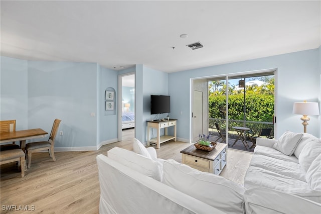 1305 Sweetwater Cv Unit 104, Naples, FL 34110 - living area featuring visible vents, light wood-type flooring, and baseboards