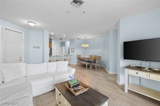 1305 Sweetwater Cv Unit 104, Naples, FL 34110 - living room with light wood finished floors, recessed lighting, visible vents, and baseboards