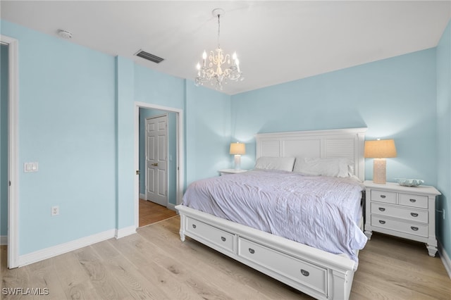 1305 Sweetwater Cv Unit 104, Naples, FL 34110 - bedroom with an inviting chandelier, visible vents, light wood-style flooring, and baseboards