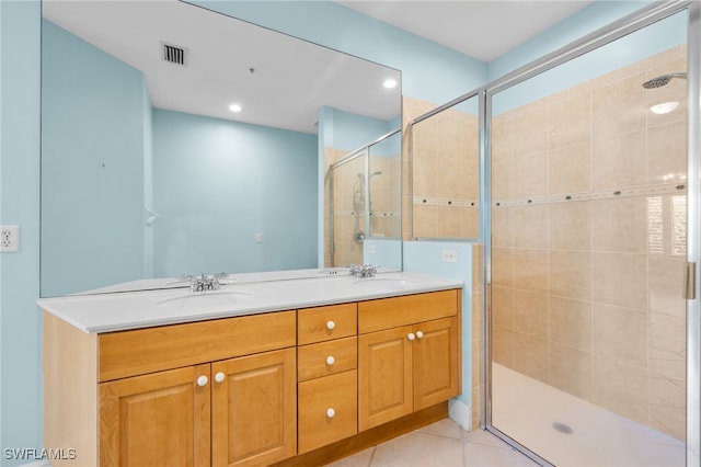 1305 Sweetwater Cv Unit 104, Naples, FL 34110 - full bathroom featuring tile patterned floors, a shower stall, double vanity, a sink, and visible vents