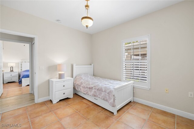 1305 Sweetwater Cv Unit 104, Naples, FL 34110 - bedroom featuring light tile patterned floors and baseboards