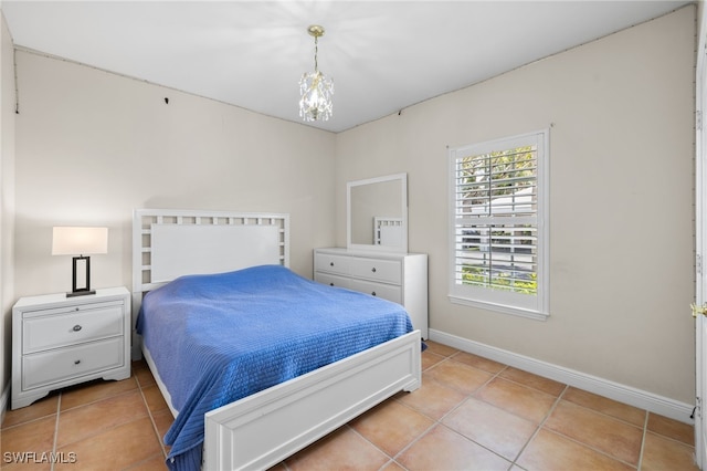 1305 Sweetwater Cv Unit 104, Naples, FL 34110 - bedroom featuring baseboards, an inviting chandelier, and light tile patterned flooring