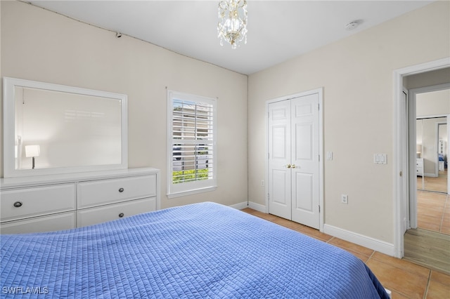 1305 Sweetwater Cv Unit 104, Naples, FL 34110 - bedroom with light tile patterned floors and baseboards