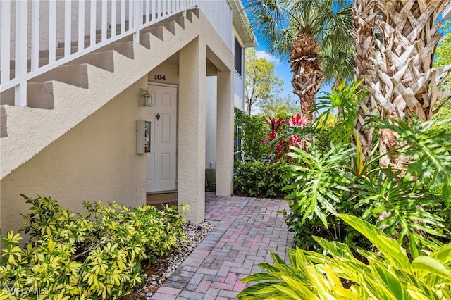 1305 Sweetwater Cv Unit 104, Naples, FL 34110 - entrance to property featuring stucco siding