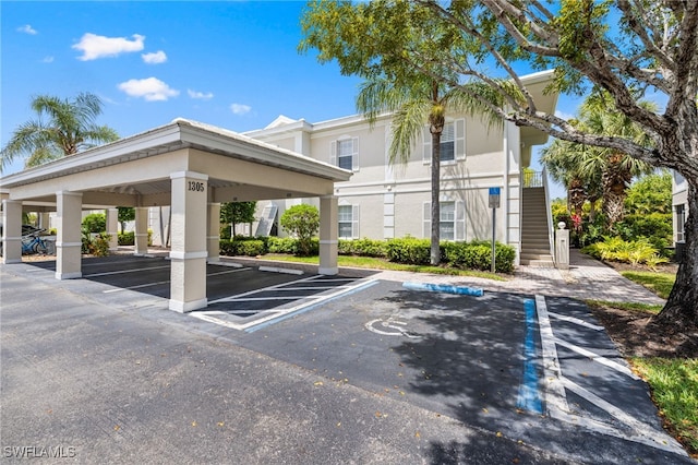 1305 Sweetwater Cv Unit 104, Naples, FL 34110 - partially covered parking lot with stairs
