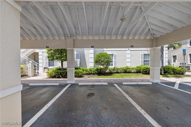 1305 Sweetwater Cv Unit 104, Naples, FL 34110 - covered parking lot with stairway