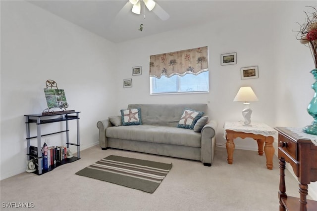 living room featuring baseboards, ceiling fan, and carpet floors