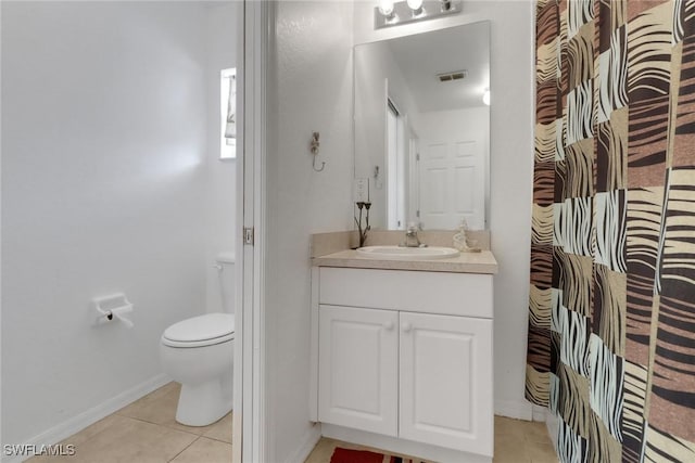 bathroom with toilet, vanity, visible vents, tile patterned flooring, and baseboards