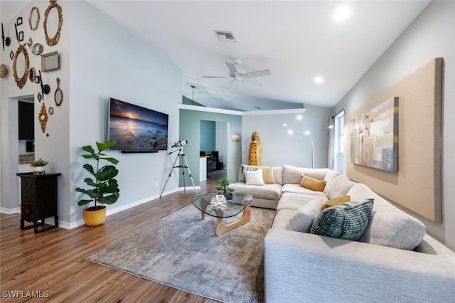 living area with wood finished floors, vaulted ceiling, ceiling fan, baseboards, and visible vents
