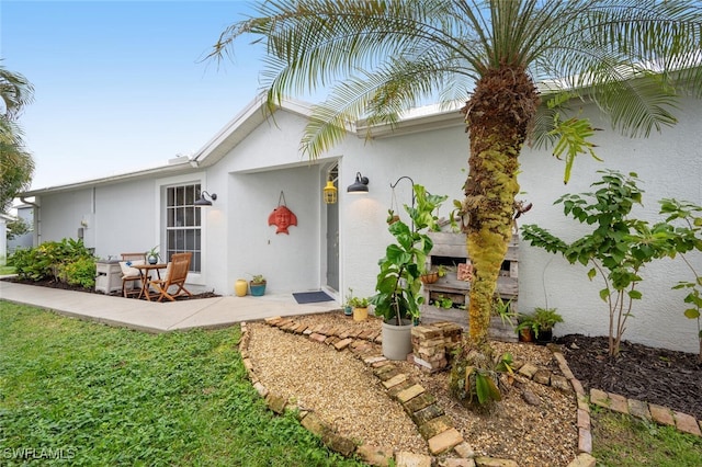 view of front facade with a patio and stucco siding