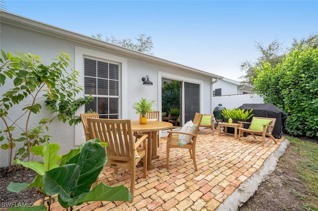 view of patio with grilling area and fence