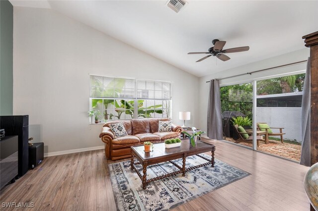living area featuring visible vents, ceiling fan, wood finished floors, and lofted ceiling