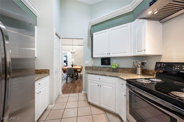 kitchen with electric range, white cabinets, freestanding refrigerator, and wall chimney exhaust hood
