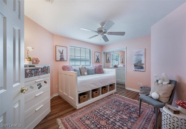 bedroom featuring wood finished floors, a ceiling fan, and baseboards