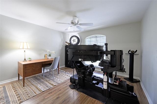 office space with wood finished floors, a ceiling fan, and baseboards