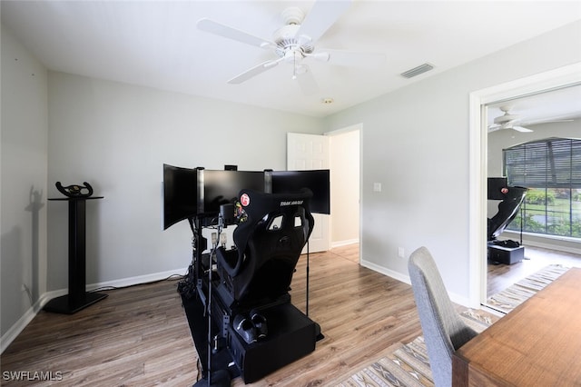 office space with ceiling fan, baseboards, wood finished floors, and visible vents
