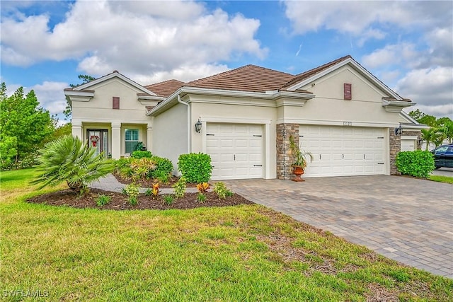 3129 Preserves Edge Ct, Fort Myers, FL 33905 - view of front of home featuring a tile roof, a front lawn, stucco siding, driveway, and an attached garage