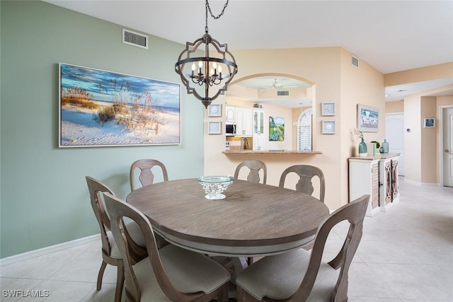 7048 Pelican Bay Blvd Unit C104, Naples, FL 34108 - dining room featuring light tile patterned floors, ceiling fan with notable chandelier, and visible vents