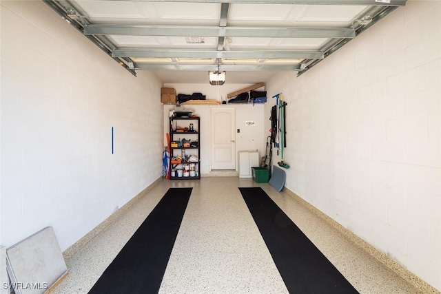 7048 Pelican Bay Blvd Unit C104, Naples, FL 34108 - garage with concrete block wall and a garage door opener