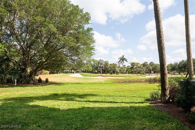7048 Pelican Bay Blvd Unit C104, Naples, FL 34108 - view of property's community featuring a lawn and view of golf course