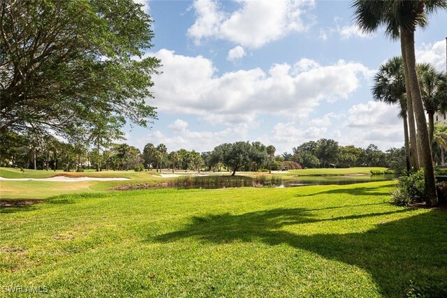 7048 Pelican Bay Blvd Unit C104, Naples, FL 34108 - view of community with a yard, a water view, and golf course view