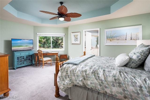 7048 Pelican Bay Blvd Unit C104, Naples, FL 34108 - bedroom featuring connected bathroom, carpet floors, a ceiling fan, baseboards, and a tray ceiling