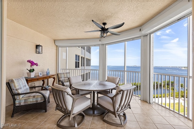 14250 Royal Harbour Ct Unit 913, Fort Myers, FL 33908 - sunroom featuring a water view, tile patterned flooring, healthy amount of natural light, a textured ceiling, and a textured wall